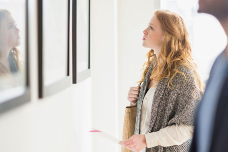Female Millennial admiring artwork in gallery 
