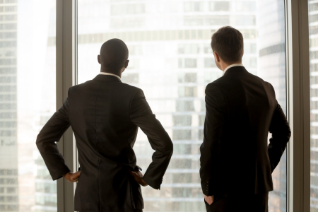 2 Business mans looking outside window