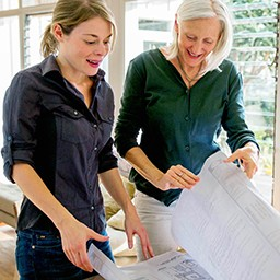 Middle-aged woman and senior woman discussing plans.